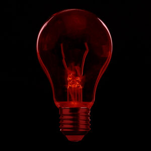 Red light bulb design in the black void. A Graphic Design by Gravity Centric Design. Graphic Designer Redding CA